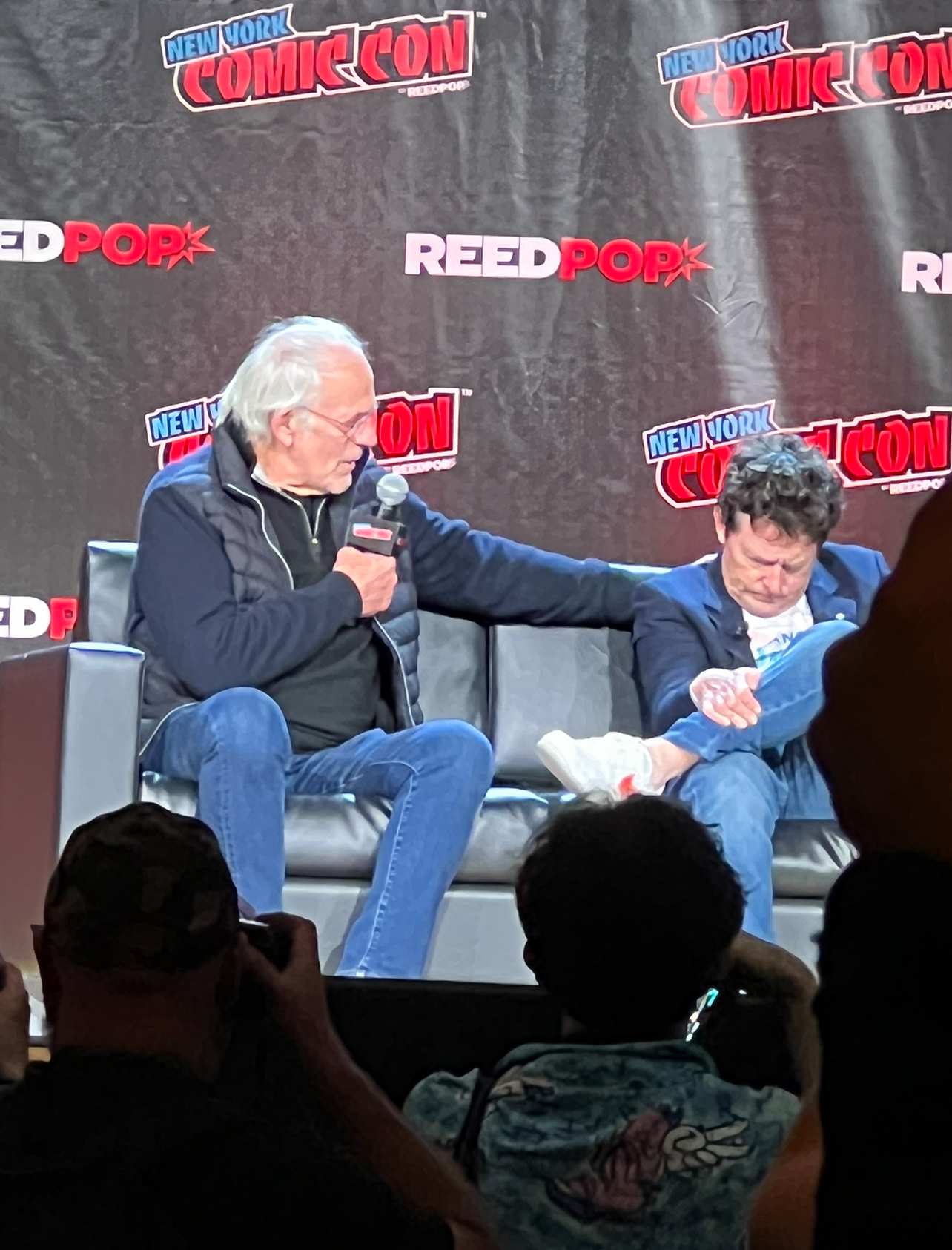 Fox and Lloyd at NYCC 2022 during the Back to the Future reunion panel        The Xavierite
